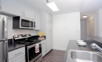 Kitchen with black appliances at Waverly, Los Angeles