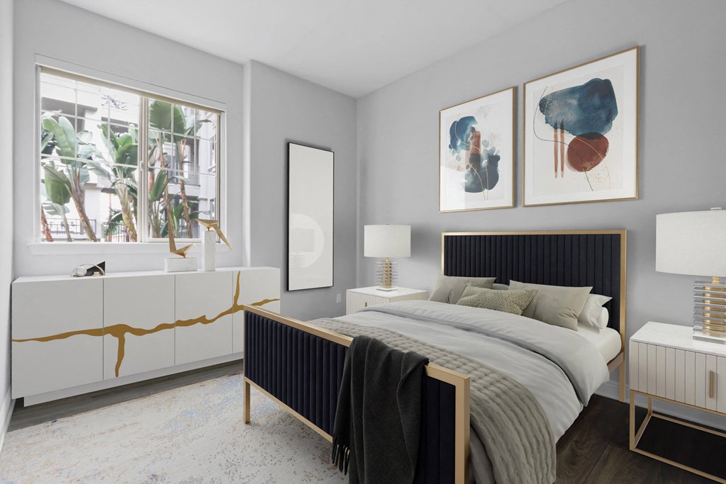 a bedroom with a bed and two paintings on the wall