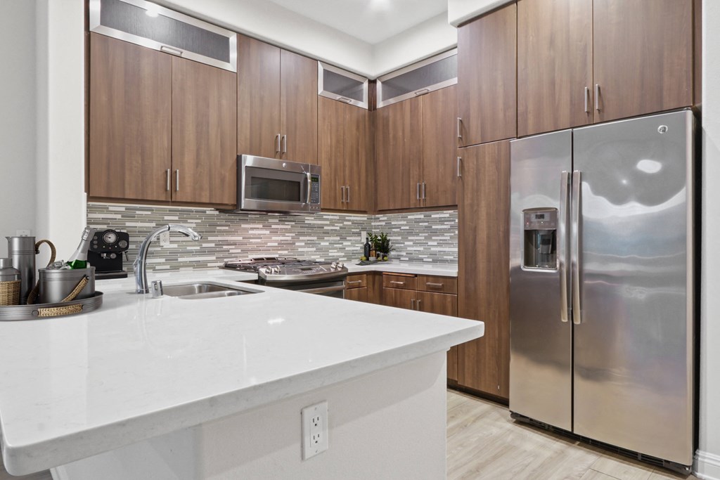 a kitchen with stainless steel appliances and a white counter top