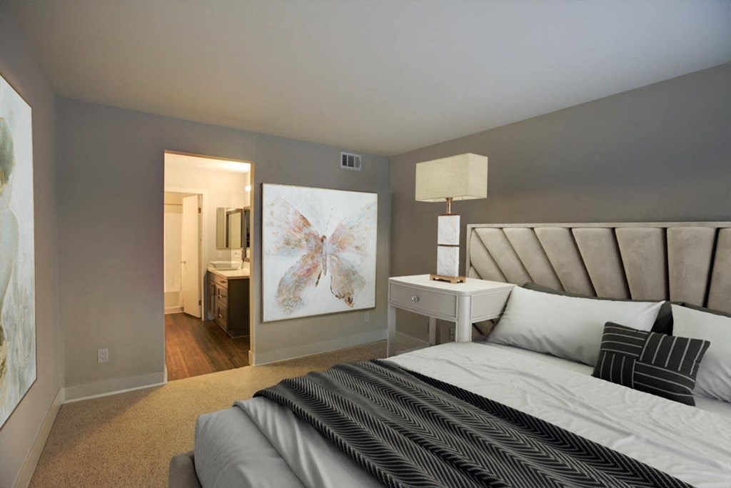 a bedroom with a bed and a painting on the wall