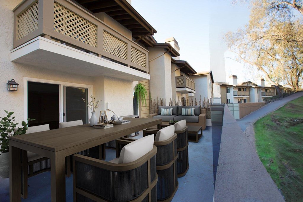 a patio with tables and chairs outside a house