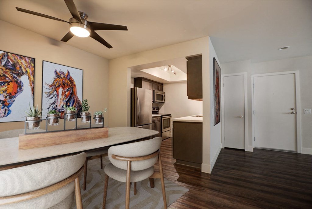 a kitchen and dining room with a table and chairs