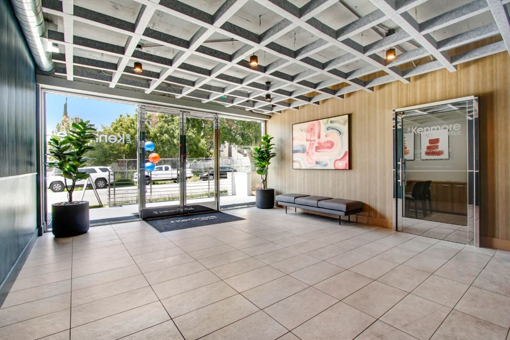 a lobby with a glass door and a glass wall with a view of the street at The Kenmore Los Feliz, Los Angeles, CA