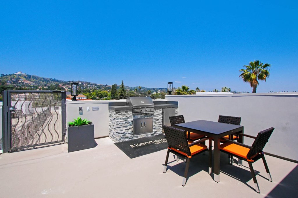 a rooftop patio with a barbecue and a table and chairs at The Kenmore Los Feliz, Los Angeles, CA, 90027-4063