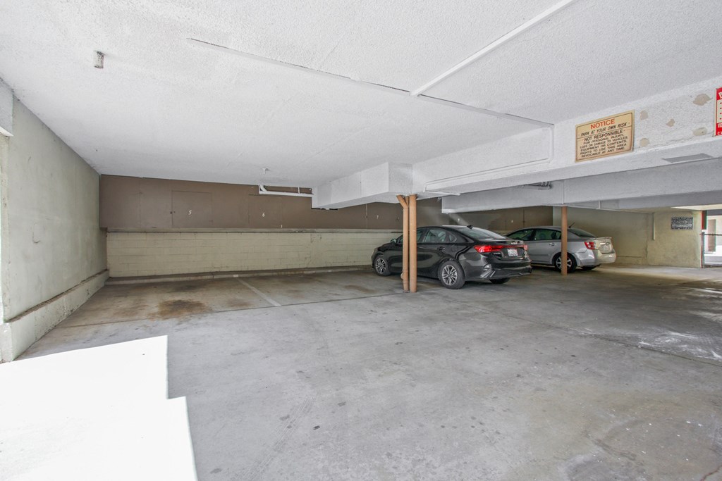 a parking garage with two cars in it