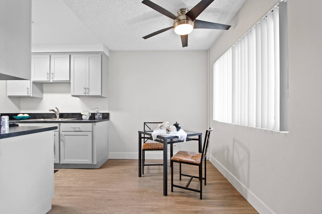 an open kitchen and dining area with a ceiling fan at Clair Del and Clair Del Gardens, Long Beach, 90807