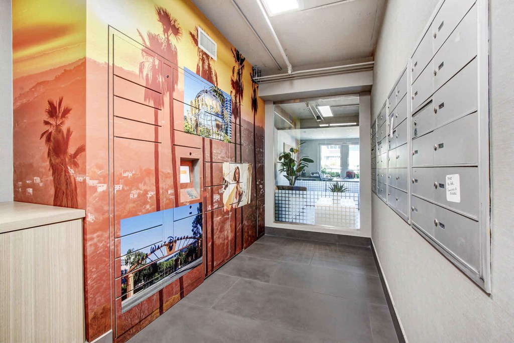 a hallway with a mural on the wall and lockers on the right at Toluca Court, Toluca Lake, CA