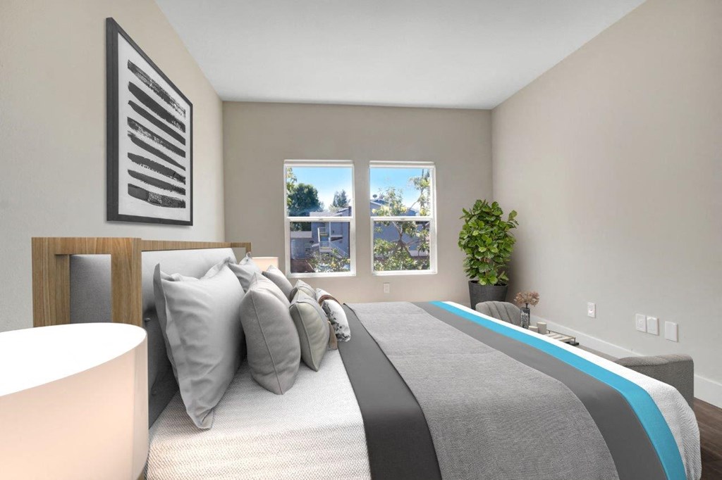 a bedroom with a bed and two windows at Toluca Court, Toluca Lake