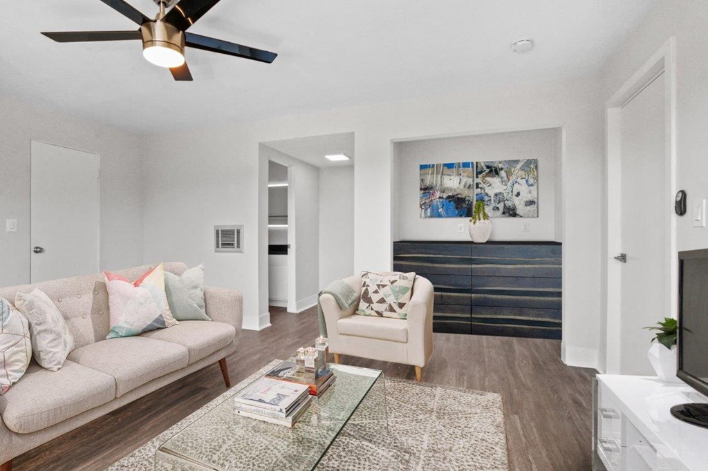 a living room with a couch and a chair and a tv