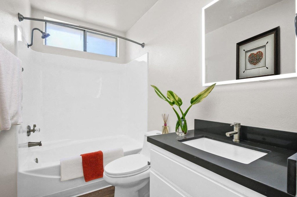 a white bathroom with a sink and a toilet