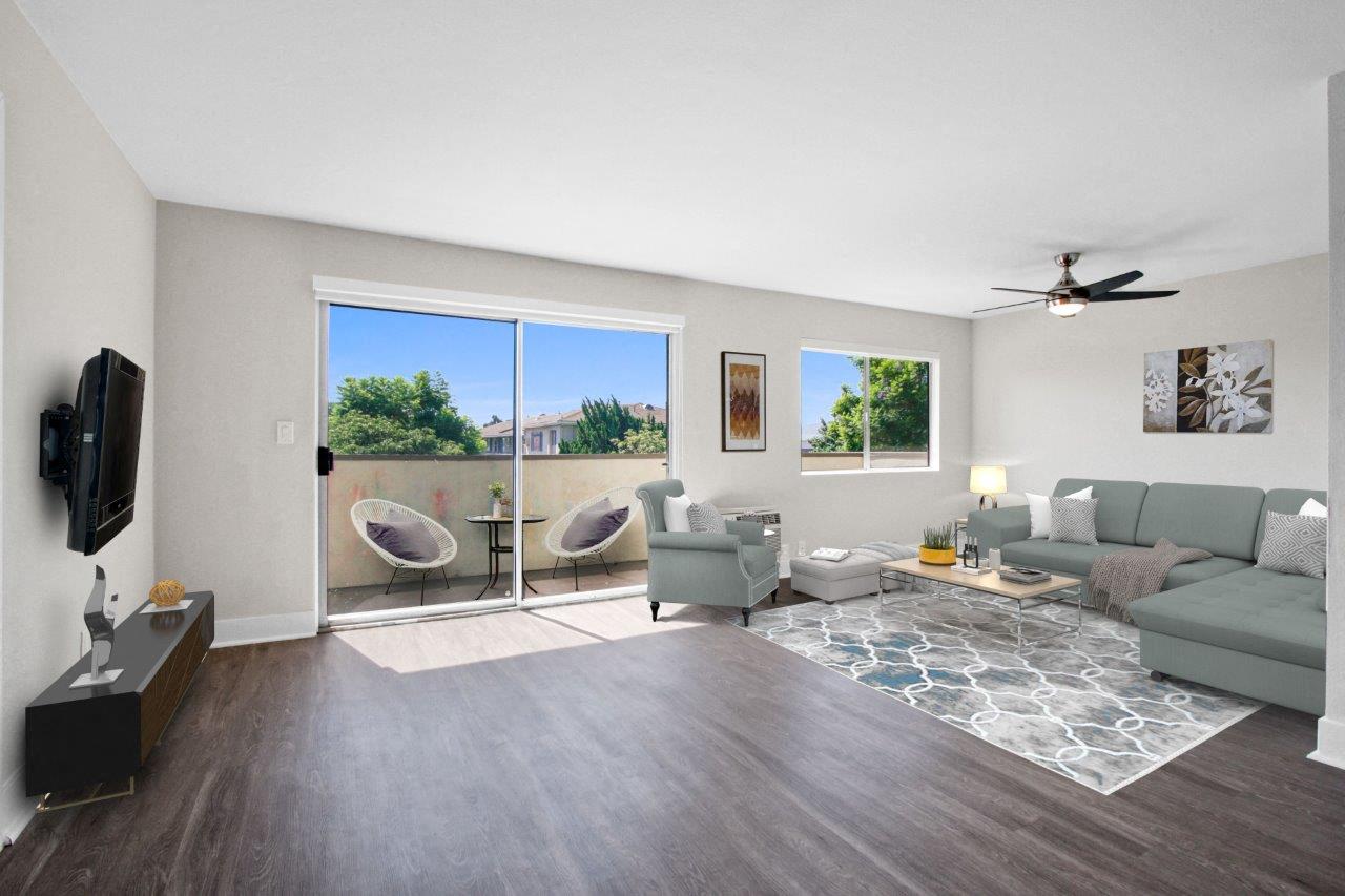a living room with a couch and a ceiling fan