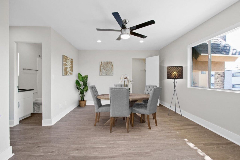 a dining room with a table and a ceiling fan