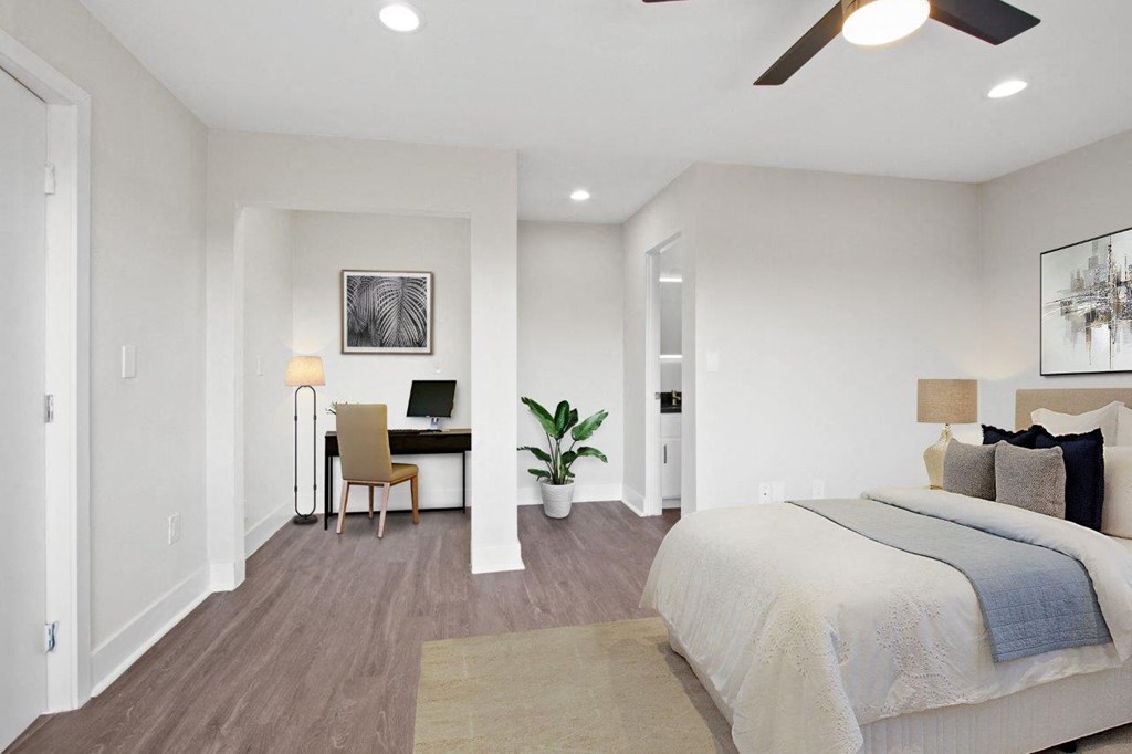 a bedroom with a bed and a desk