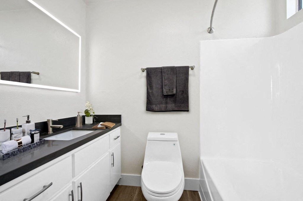 a white bathroom with a toilet and a sink