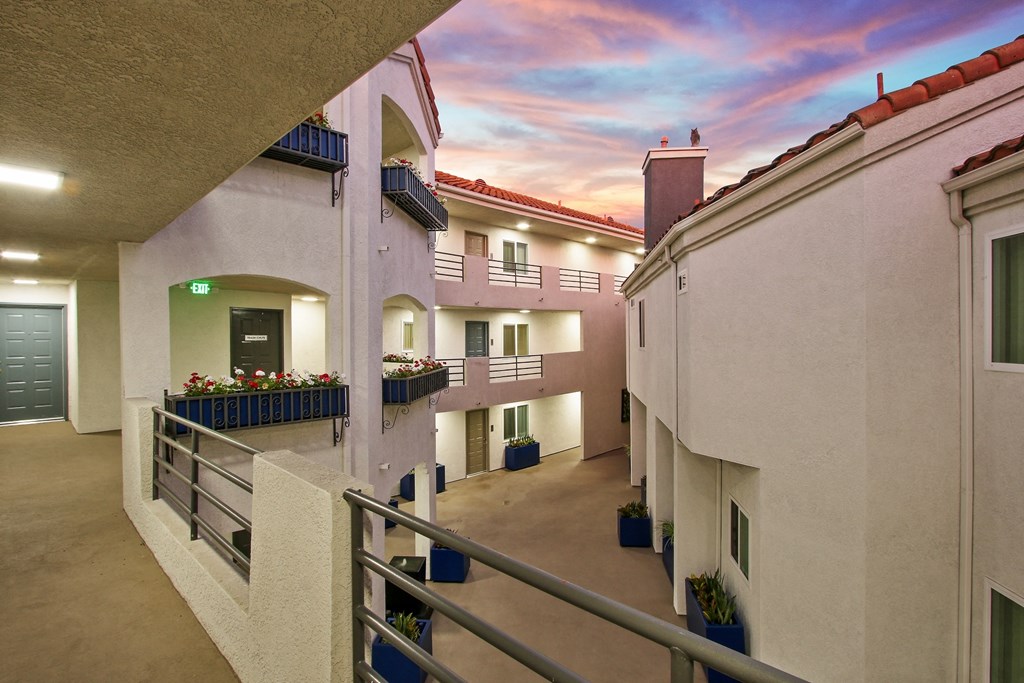 a balcony with a view of a colorful sky