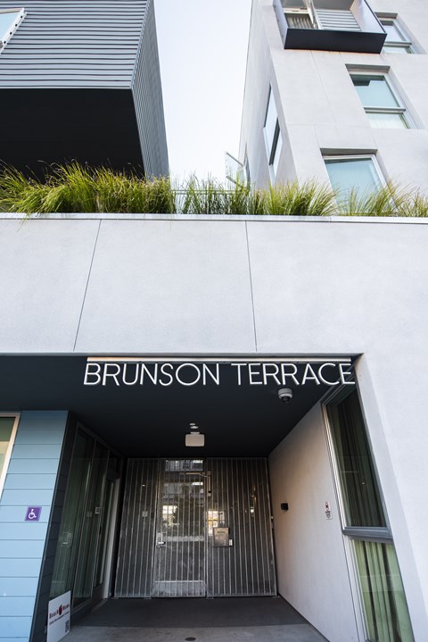 The entrance to a building with the name Brunson Terrace on it.