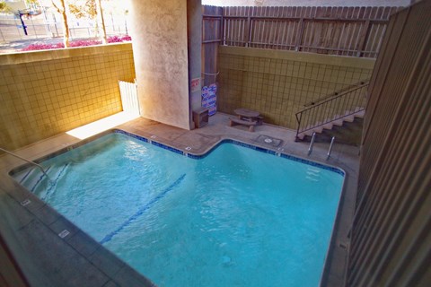 A small pool with a metal railing around it.