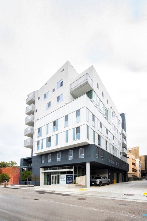 711 Colorado modern, sleek, multi-story apartment building with a white and black exterior.