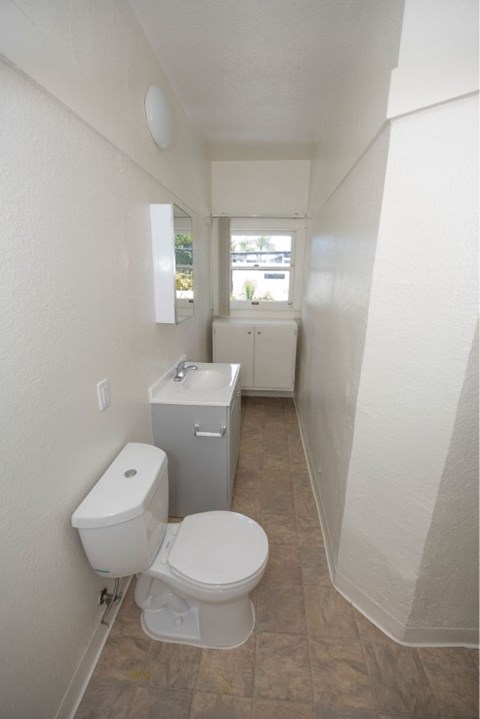 A white toilet sits in a small bathroom.