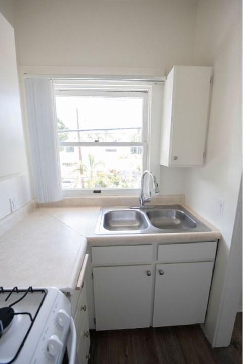 A small kitchen with a stove and sink.