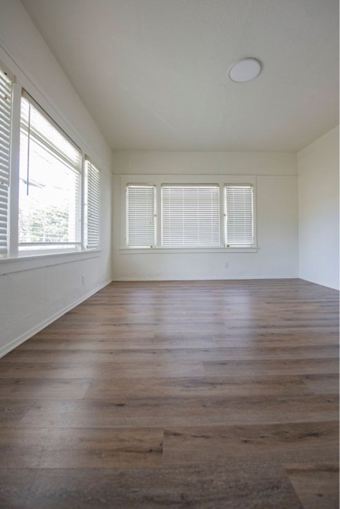 A room with wooden floors and white walls.