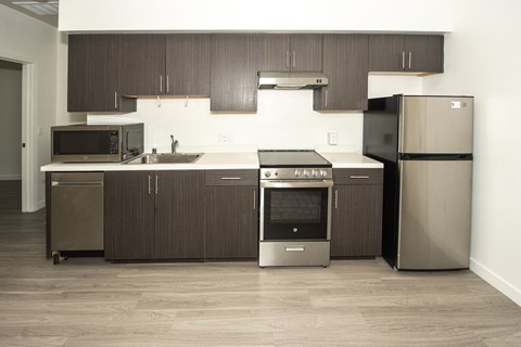 a kitchen with stainless steel appliances and wooden cabinets