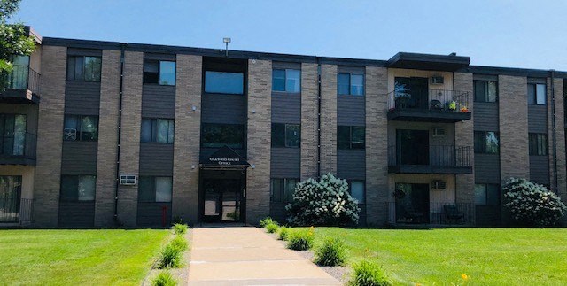 a large brick building with a sidewalk in front of it