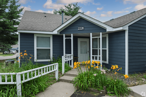 A blue house with the number 2226 on the front door.