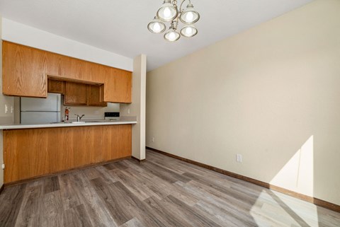 A kitchen with wooden cabinets and a refrigerator.
