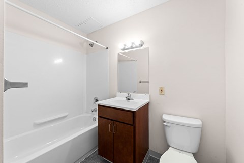 A white toilet sits next to a sink in a small bathroom.