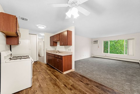 A kitchen with wooden cabinets and a white stove.