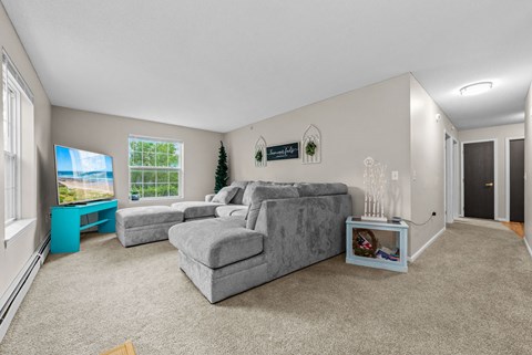 A living room with a grey couch and a blue side table.