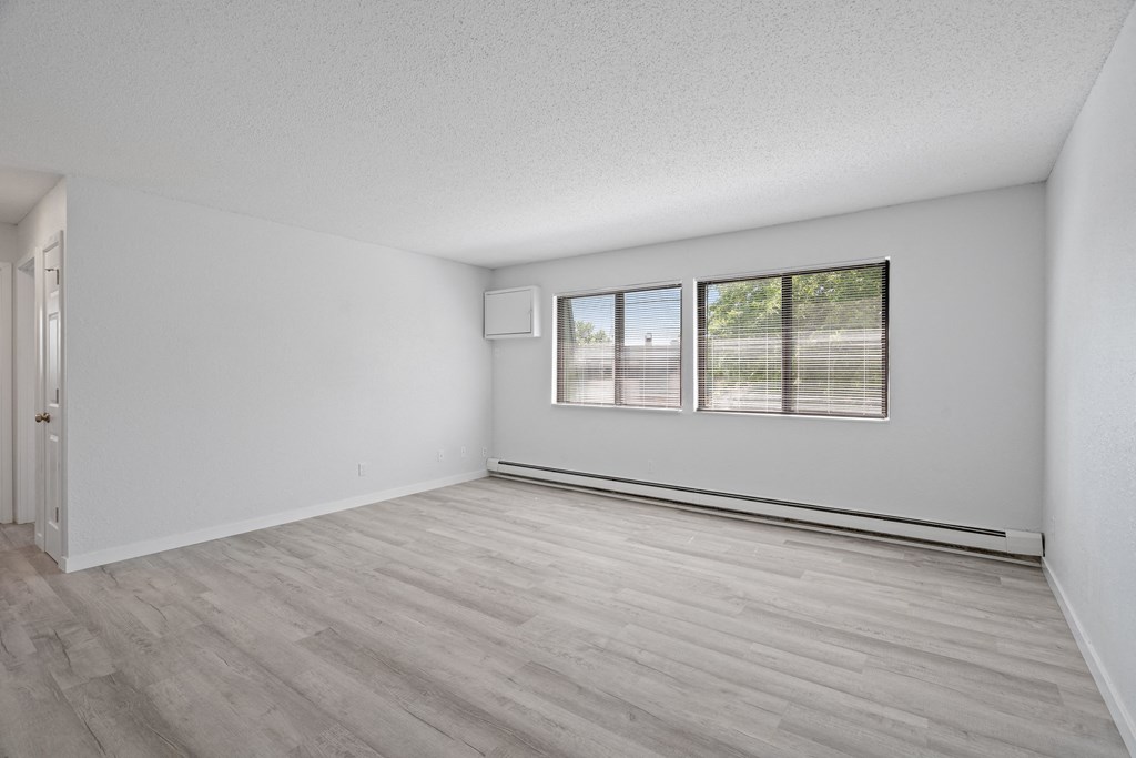 an empty room with a window and a door