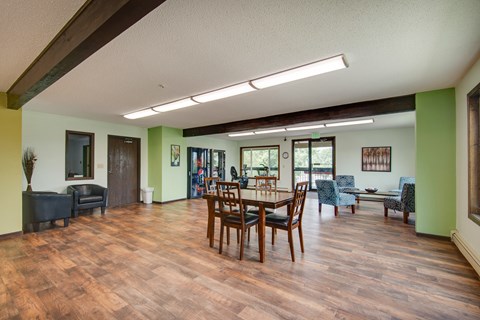 a dining room with a wooden table and chairs
