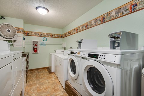 a laundry room with washing machines and other appliances
