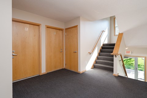 the entrance to a building with a staircase and two doors