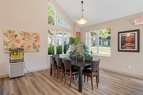 the dining room of a house with a table and chairs