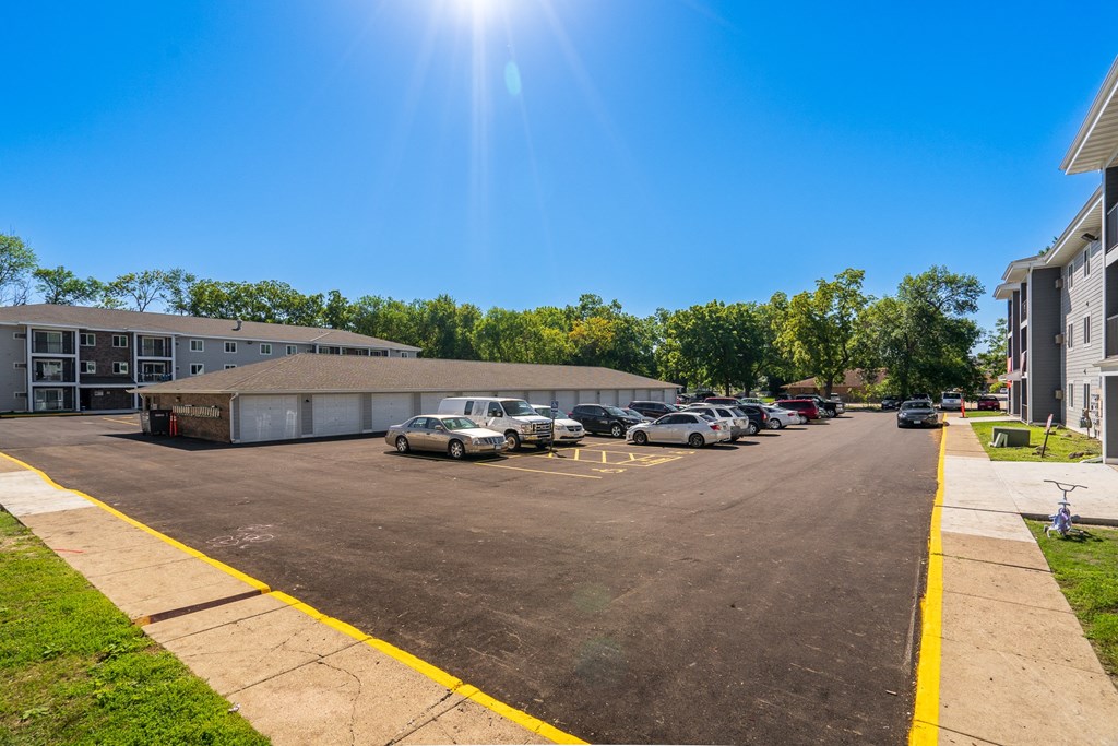 a parking lot with cars in front of a building