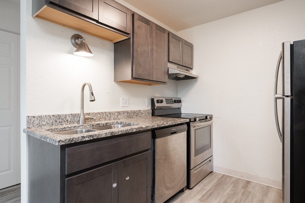 a kitchen with stainless steel appliances and a granite counter top