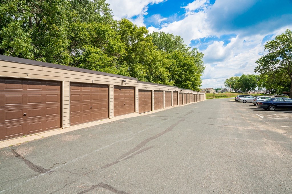 a long row of garage doors in a parking lot