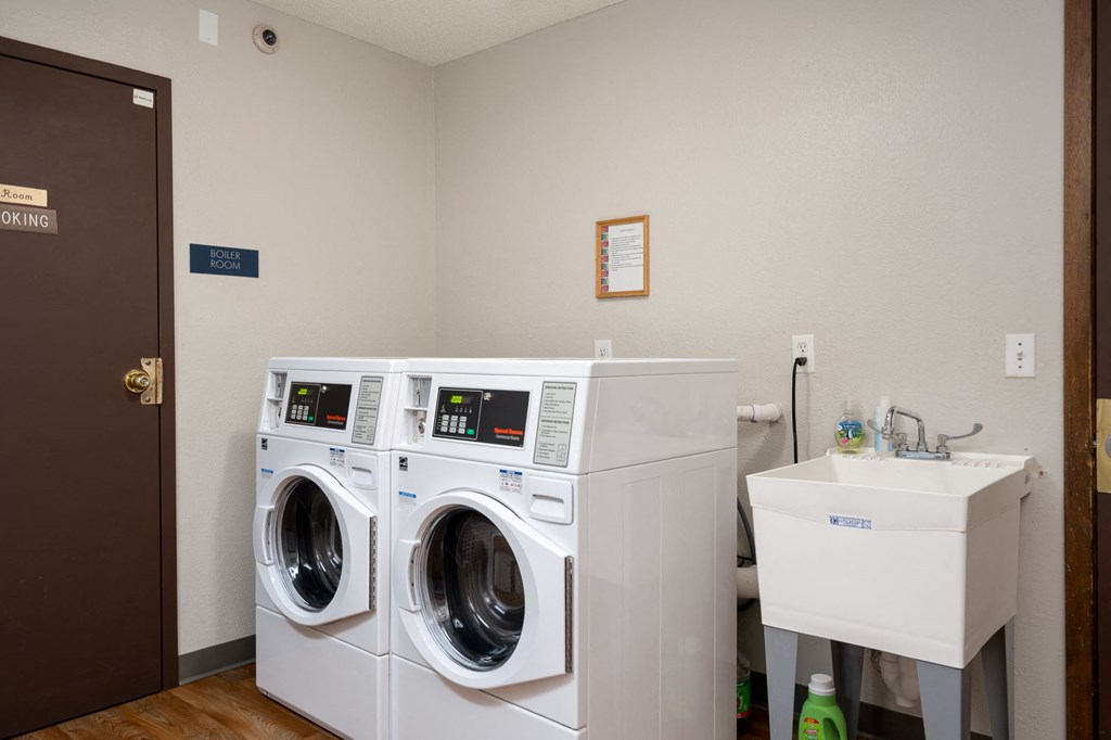 a laundry room with a washing machine and a sink