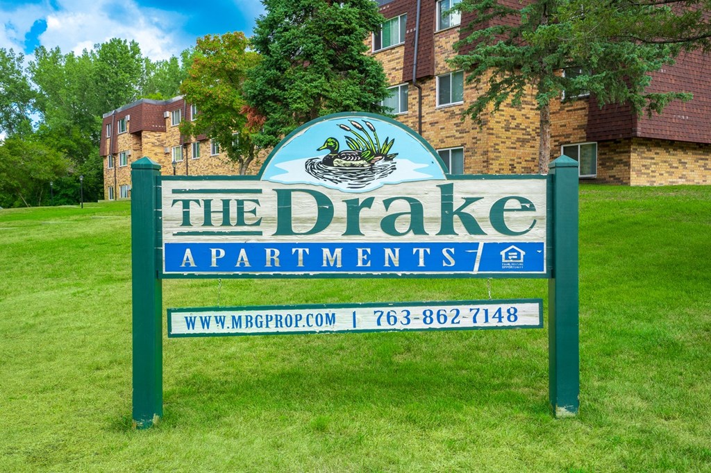 the drake apartments sign in front of building