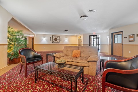a living room with a couch and chairs and a coffee table
