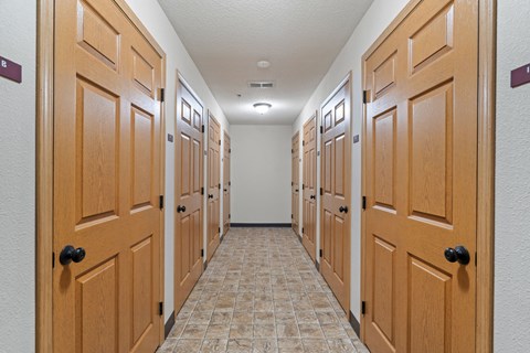 a row of closets in a room with wooden doors