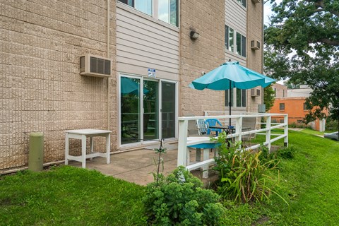 a patio with an umbrella outside of a building