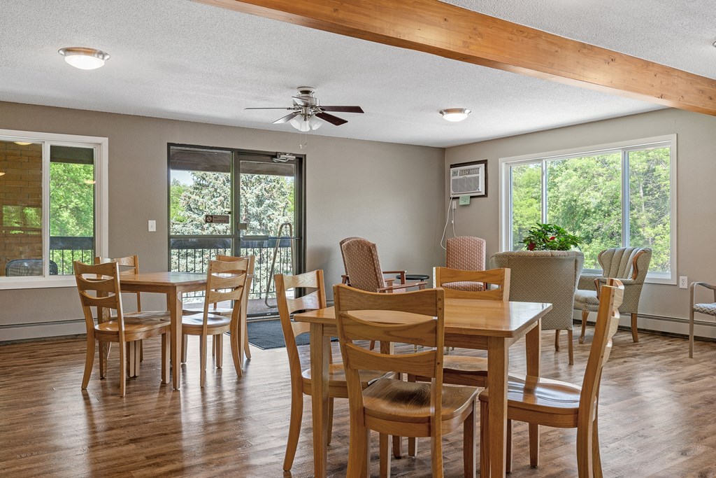 a dining room with a table and chairs and a ceiling fan