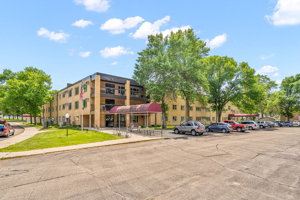 a large building with cars parked in a parking lot