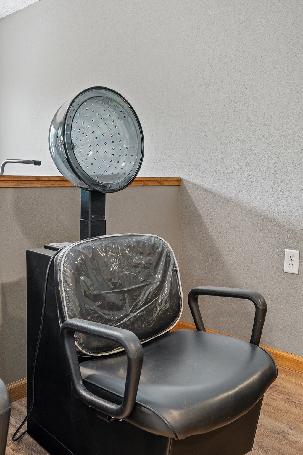 a dentist chair in a room with a fan