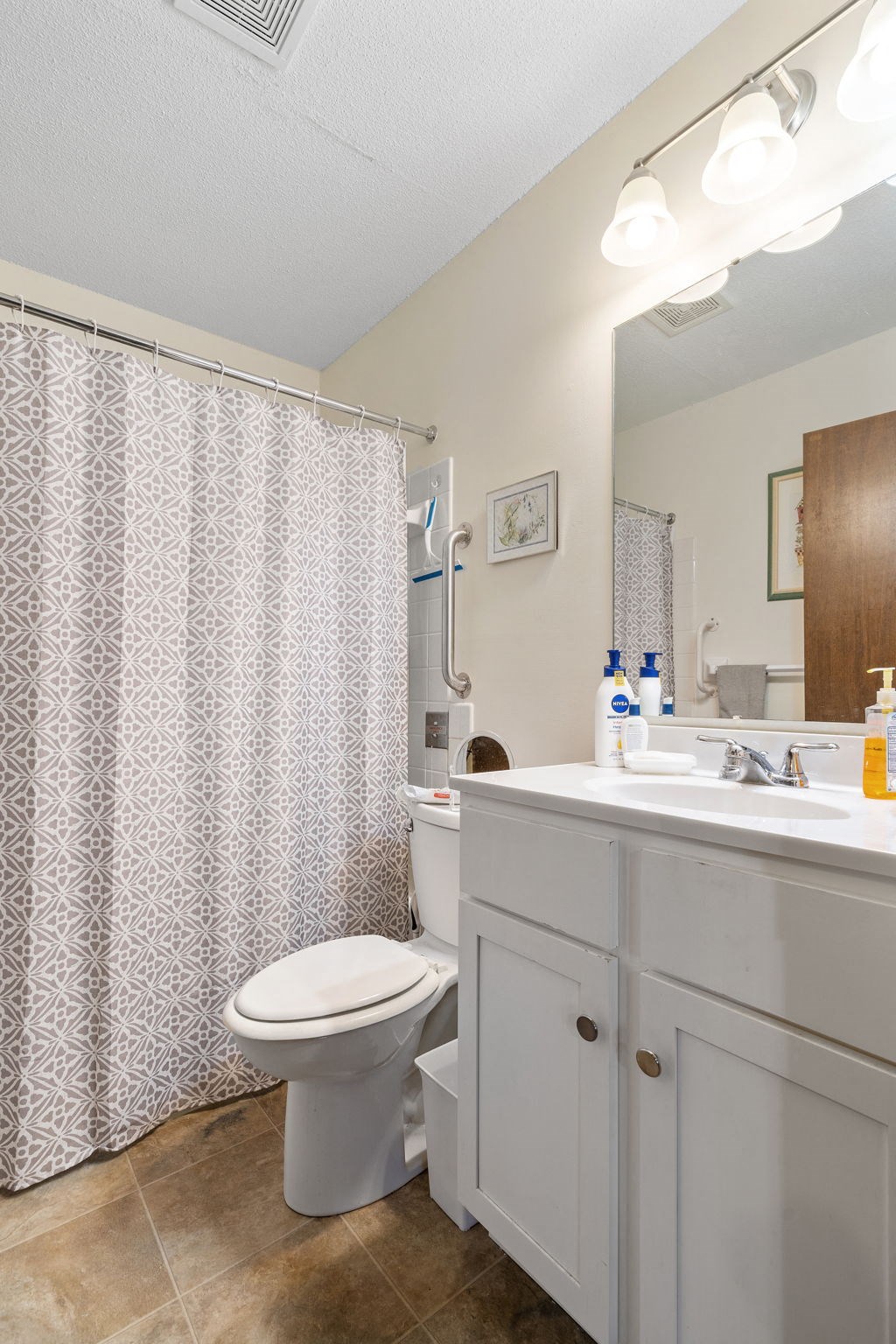 a bathroom with a shower and a toilet and a sink