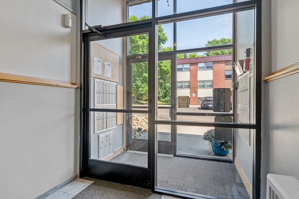 the entrance of a building with glass doors and a view of the street